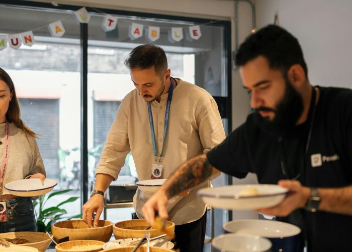 People enjoying a casual lunch buffet in a modern office setting.