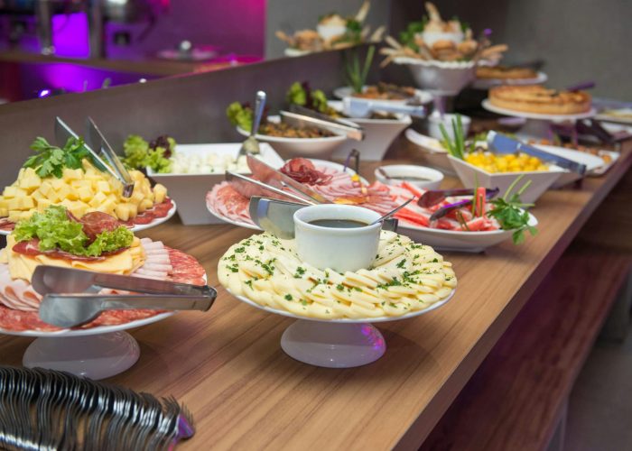 A delicious indoor buffet with assorted dishes on a wooden table.